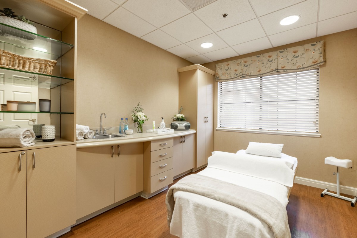 A calming treatment room equipped with a massage table and essential amenities.