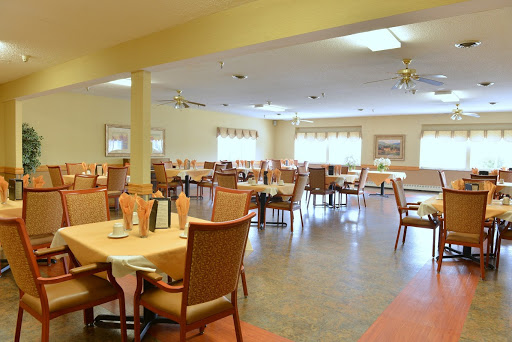 A spacious and inviting dining area featuring neatly arranged tables and chairs, perfect for casual meals.
