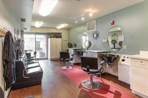 A well-lit hair salon interior with styling stations and mirrors.