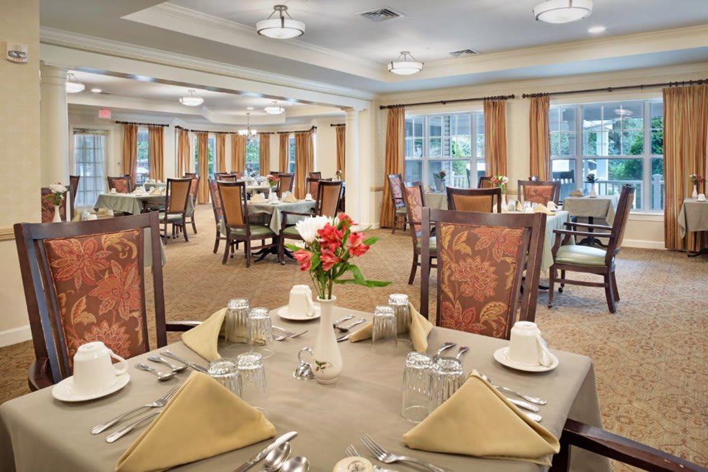 Elegant dining room with neatly arranged tables and chairs.