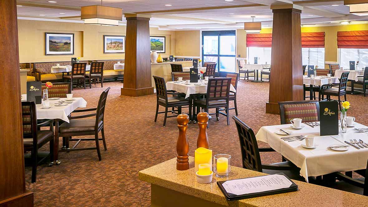A cozy restaurant interior with neatly arranged tables and chairs.