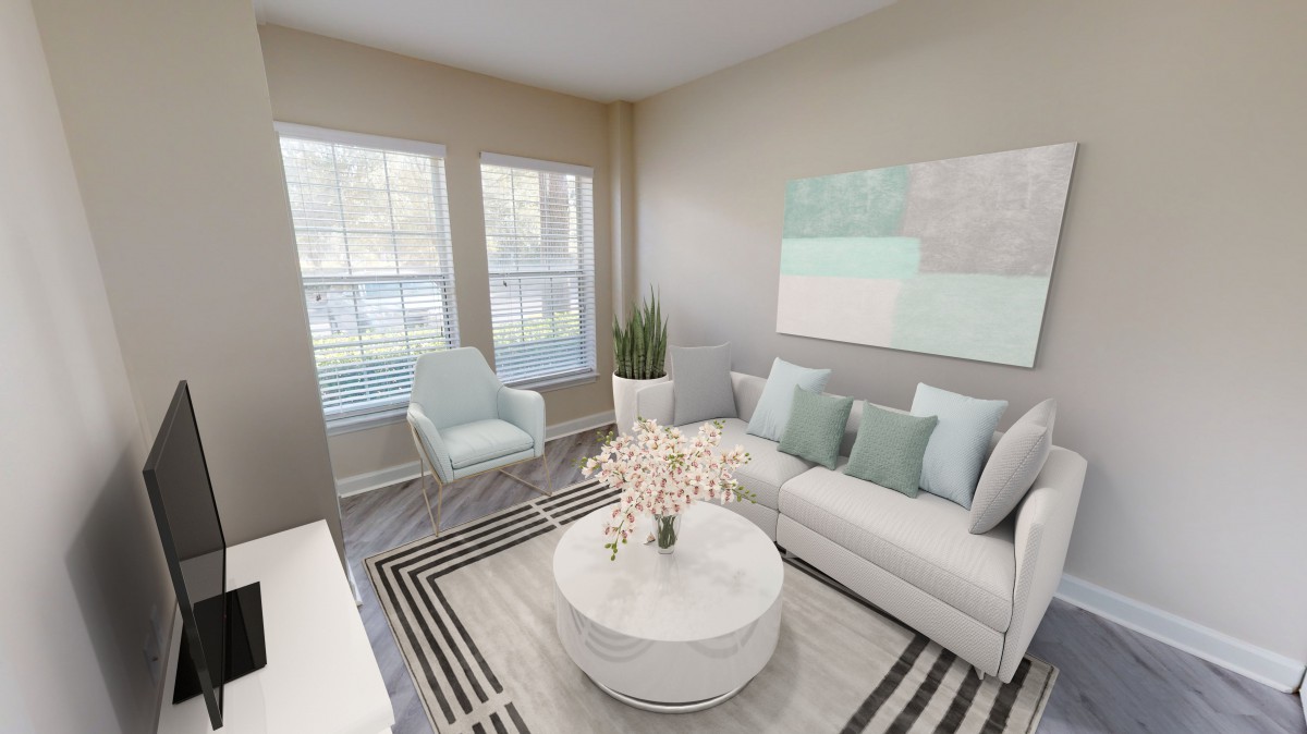 A modern and minimalist living room featuring light colors and sleek furnishings.
