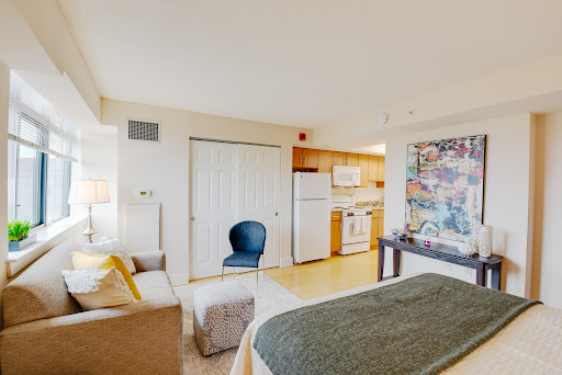 A cozy and modern studio apartment with a kitchenette and inviting decor.