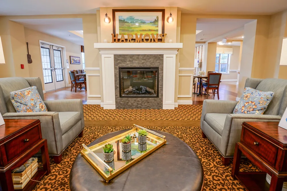 A cozy living room featuring a fireplace, comfortable seating, and elegant decor.