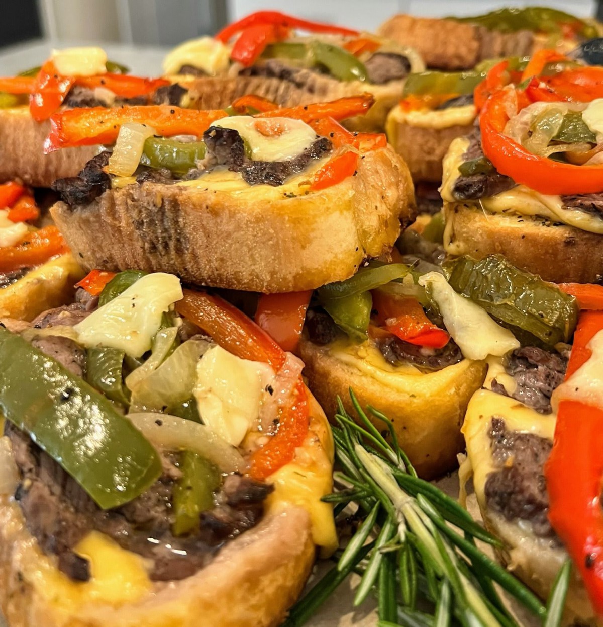 A delicious assortment of savory appetizers featuring bread topped with colorful bell peppers and vegetables.