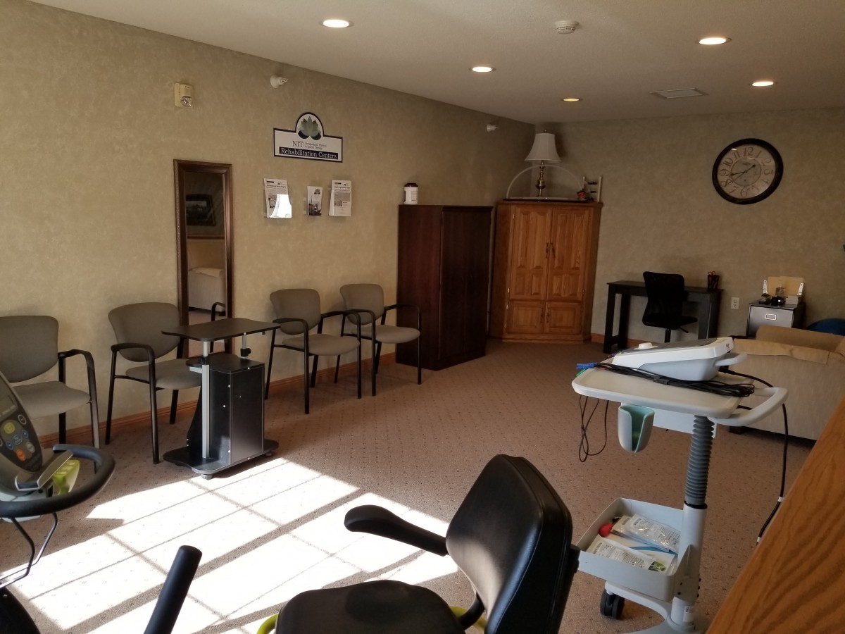 A waiting room with chairs and office furniture.