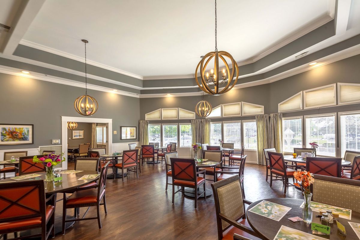 A well-lit dining area with modern decor and large windows.