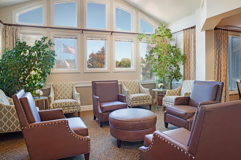 A cozy lounge area with comfortable chairs and large windows allowing natural light in.