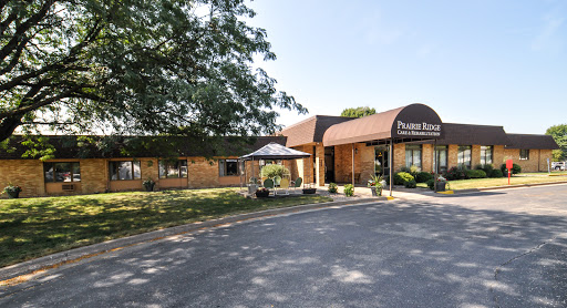 A welcoming view of a commercial building on a sunny day, featuring landscaped surroundings and a clear entrance.