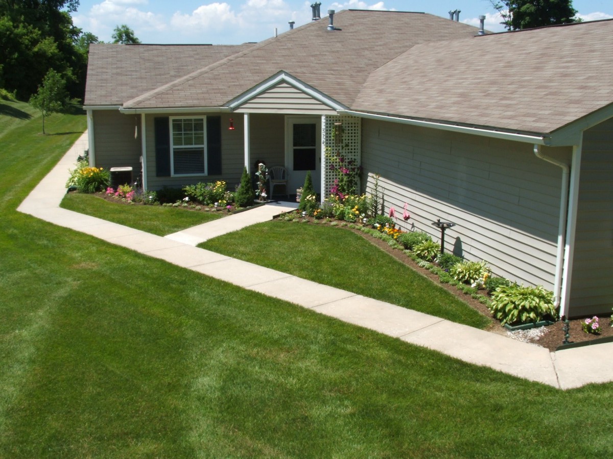 A suburban house with neatly maintained lawn and pathway.