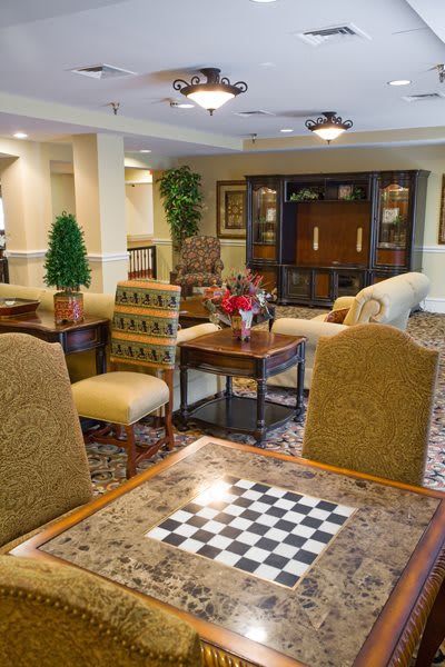 A cozy living room with classic furniture and a chessboard on the table.