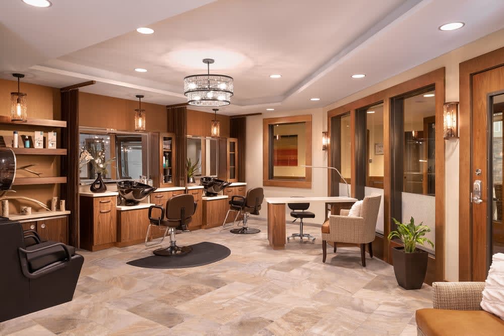 A modern and well-designed salon interior featuring styling stations and comfortable seating.