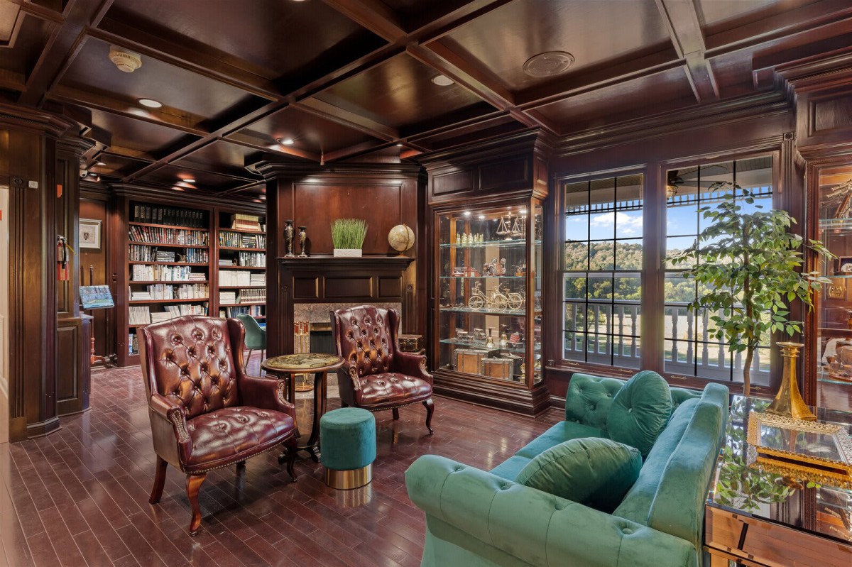 A cozy library with classic wood paneling, leather chairs, and vintage decor.