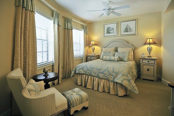 A cozy and elegantly decorated bedroom with classic furniture and soft lighting.