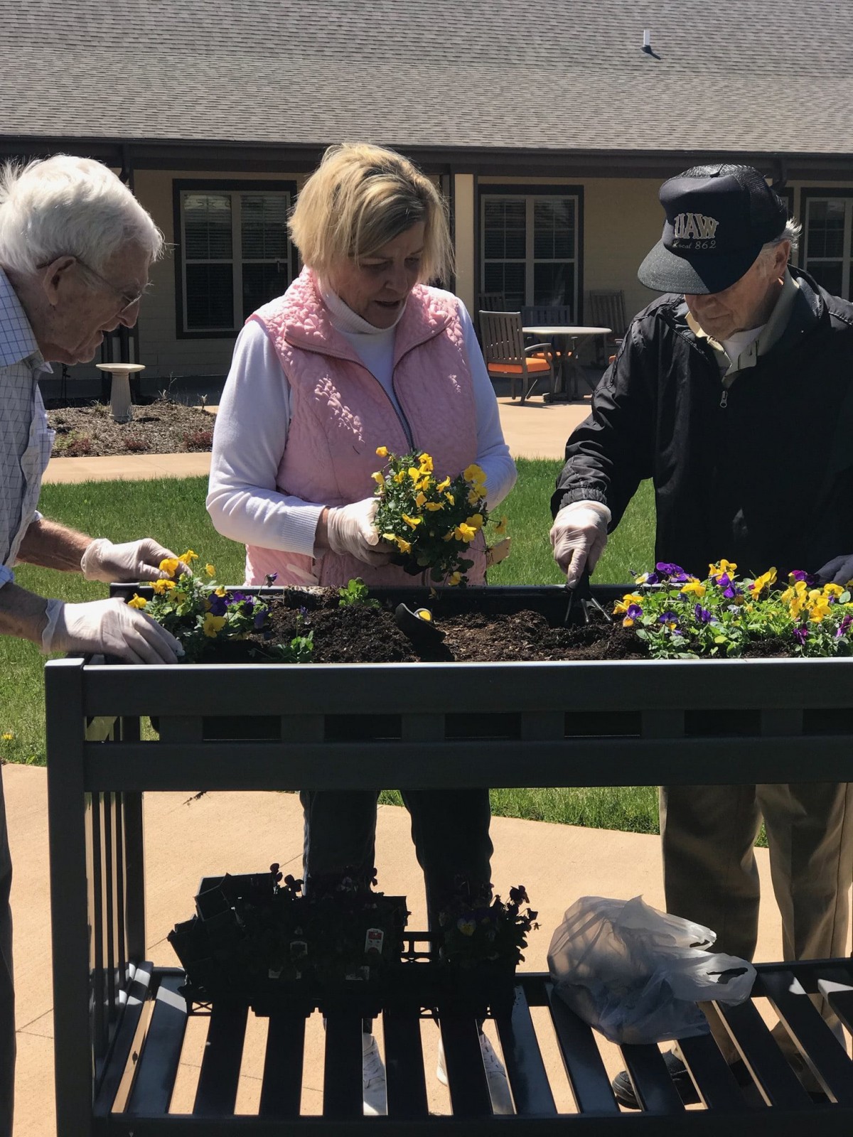 A group of people gardening outdoors together.