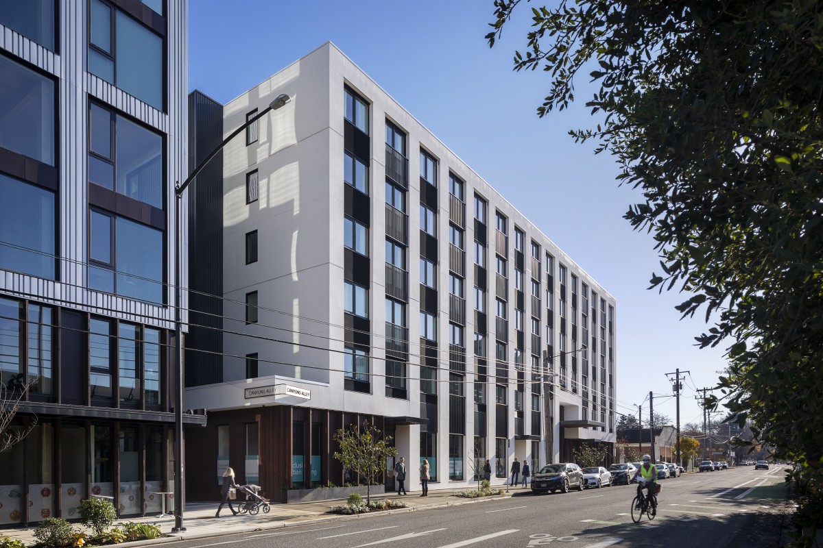 A modern residential building on a busy urban street.