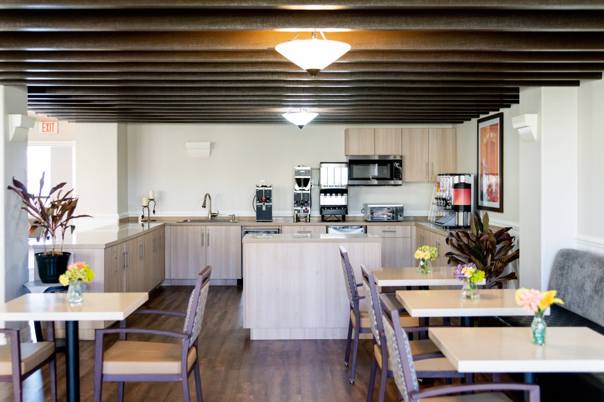 A modern kitchen area with wooden furniture and appliances.