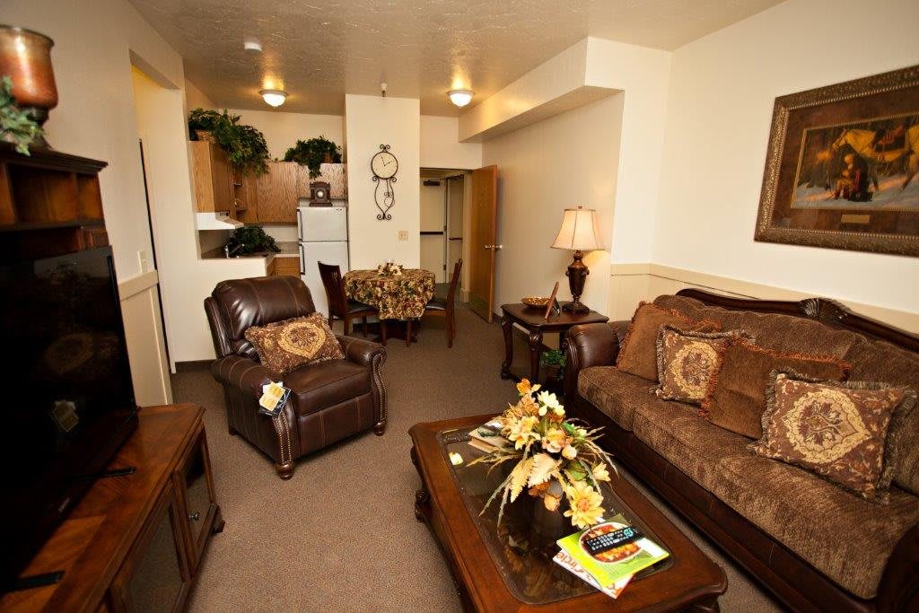 A cozy and warmly decorated living room with comfortable seating and tasteful furnishings.