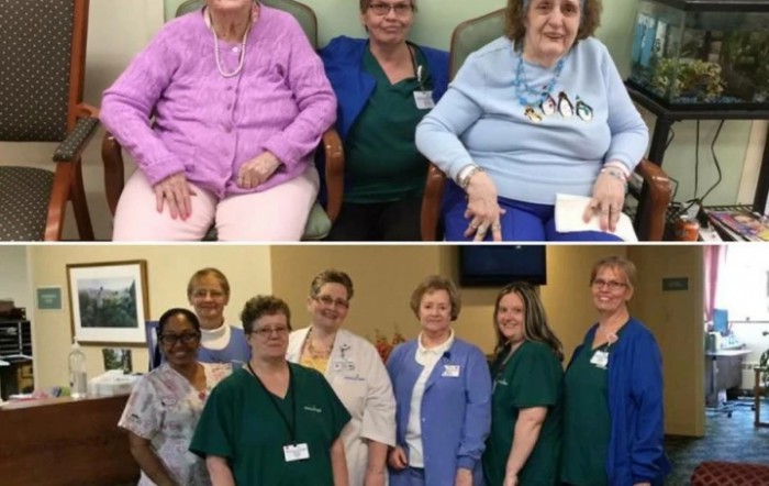 A group photo of elderly individuals with their caregivers in a healthcare setting.