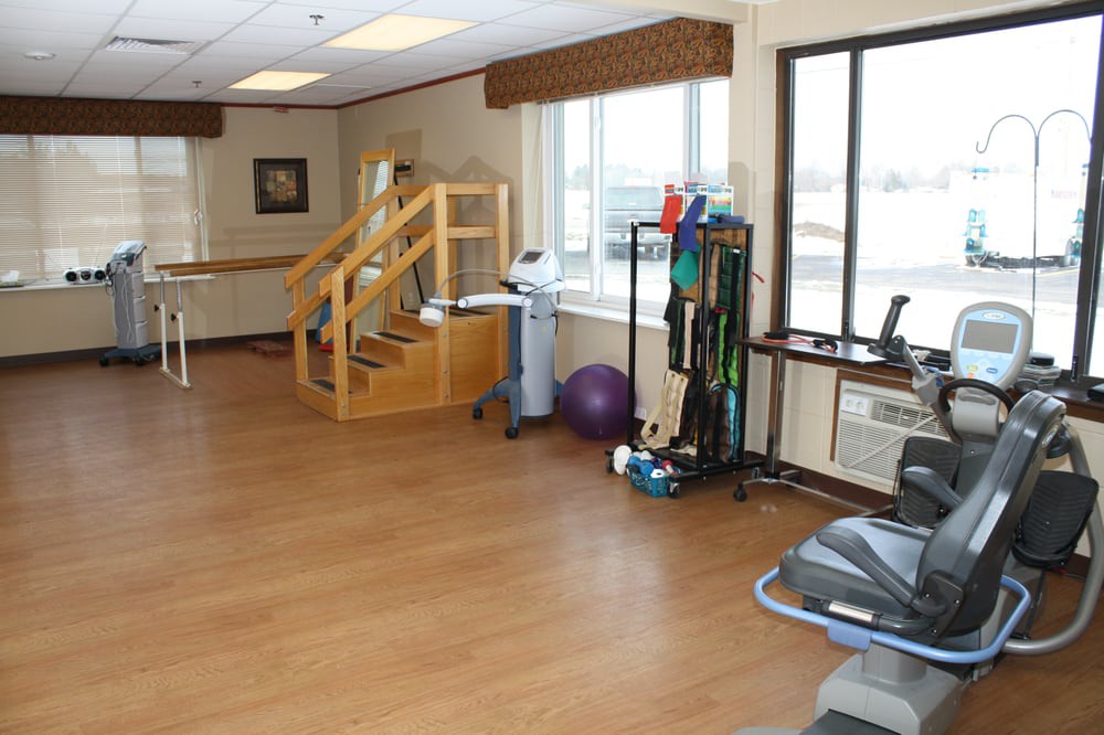 A well-equipped indoor gym space with various exercise and rehabilitation equipment.