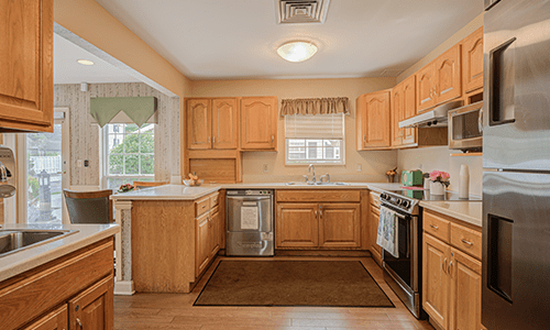 A cozy kitchen with wooden cabinets and modern appliances.
