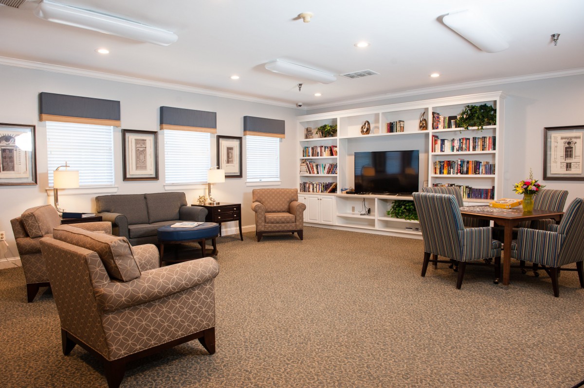 A cozy living room with comfortable seating and a large television.