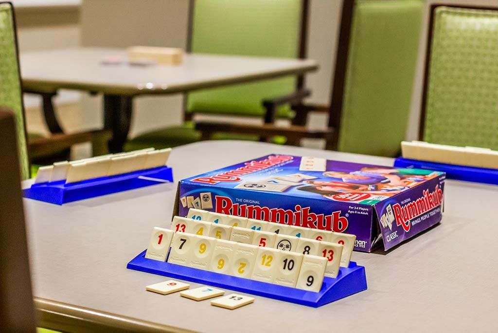 A Rummikub game set up on a table, ready for play.