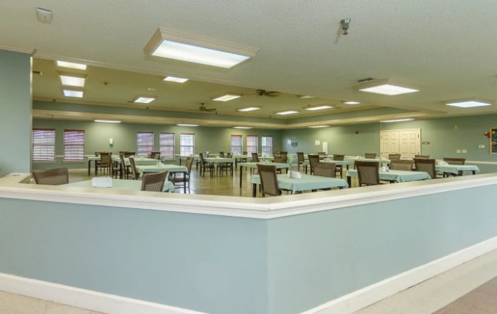 A spacious dining area with neatly arranged tables and chairs.