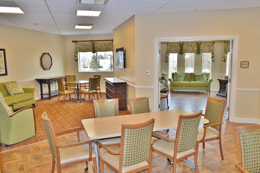 A spacious and well-lit common area featuring dining and relaxing spaces.
