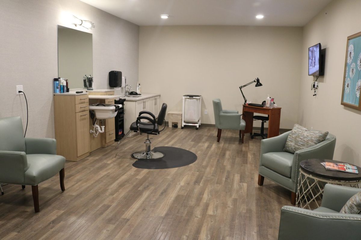A modern salon interior featuring a hair styling station and comfortable waiting area.