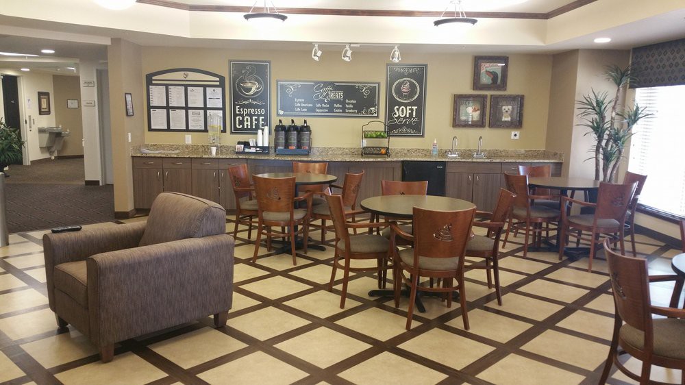 A cozy cafe interior with tables and chairs arranged neatly, offering a welcoming atmosphere.