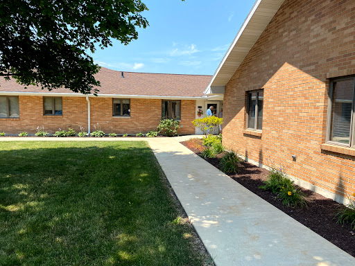 A well-maintained residential building with a landscaped yard and a clear pathway.