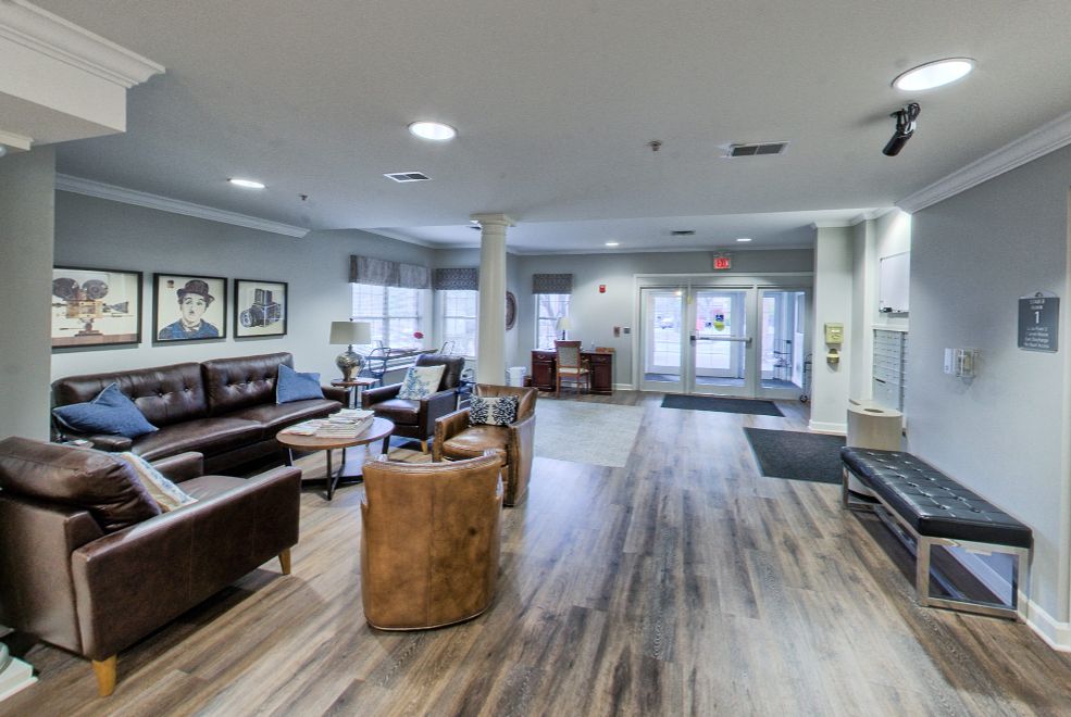 A modern lobby area featuring comfortable seating and wooden flooring.