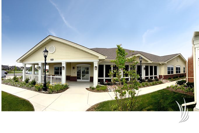 A residential building with a landscaped pathway on a sunny day.
