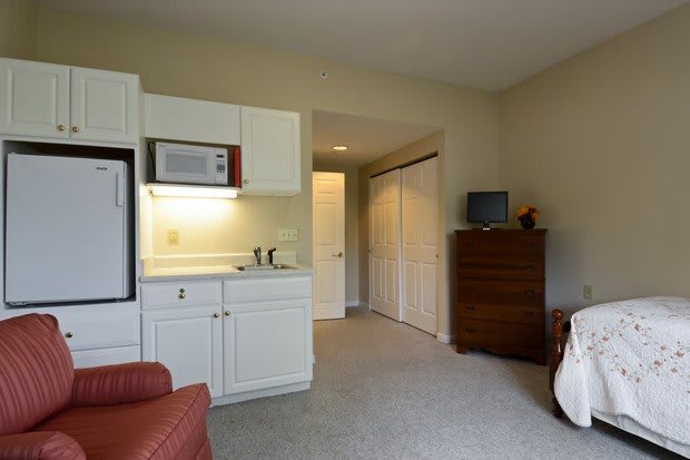 A cozy apartment with a small kitchen area and living space.