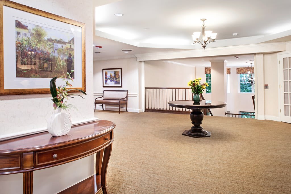 A spacious lobby area with elegant furniture and artwork on the walls.