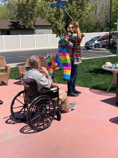 A vibrant community event where a performer engages with attendees, including an individual in a wheelchair, creating a lively atmosphere.
