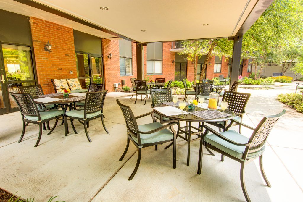 An inviting outdoor patio with tables and chairs set for a pleasant dining experience.