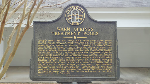 A historical marker detailing the significance of the Warm Springs treatment pools in Georgia.