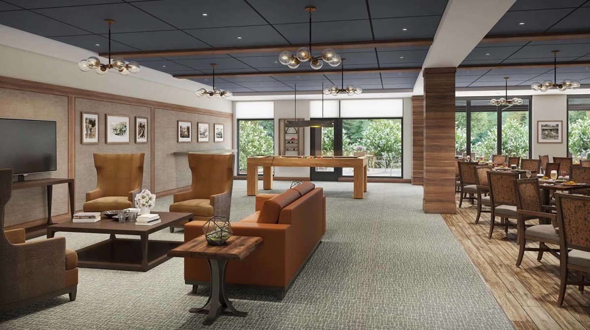 A modern lounge area featuring comfortable seating, stylish lighting, and wood accents with large windows offering a view of the outdoors.