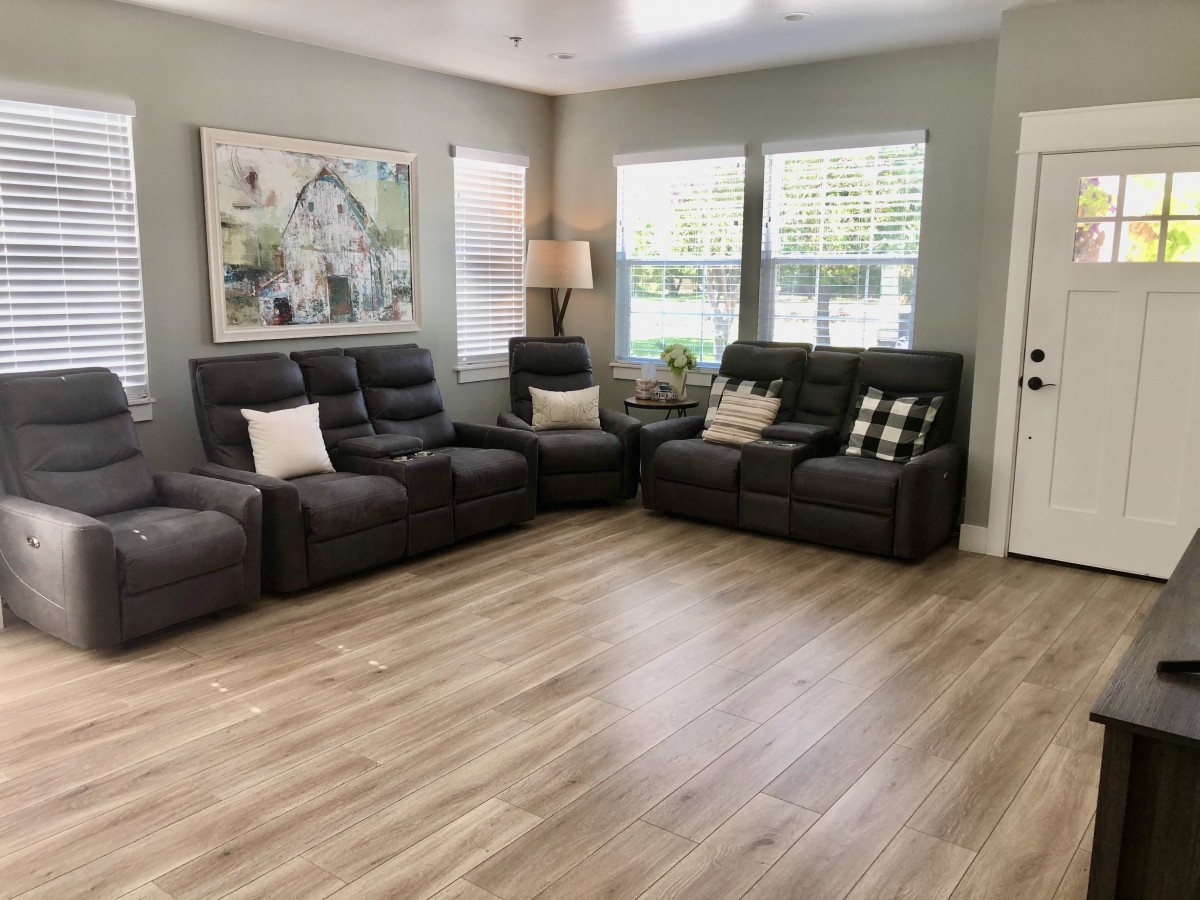 A cozy living room with comfortable seating and large windows.