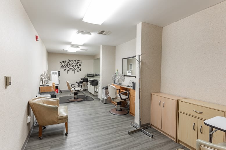 A modern hair salon interior featuring styling chairs, mirrors, and contemporary decor.