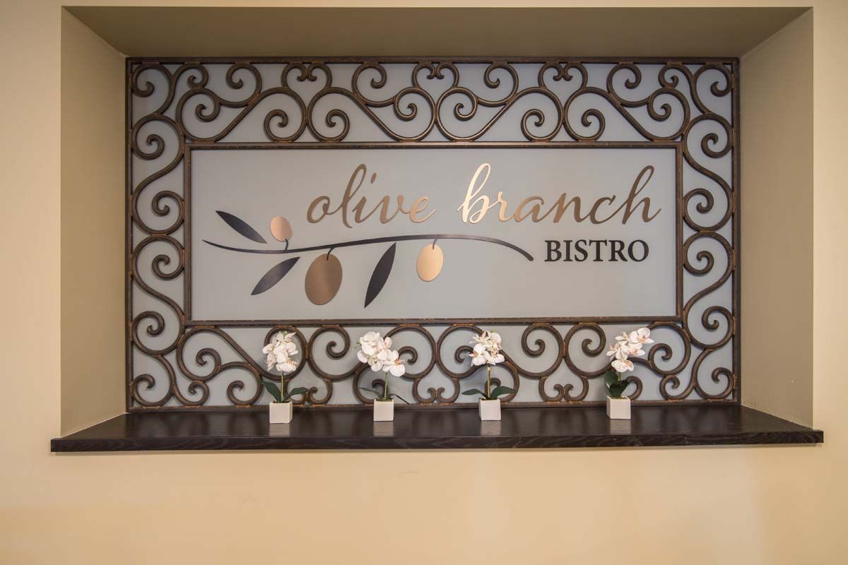 A decorative sign for Olive Branch Bistro inside the restaurant.