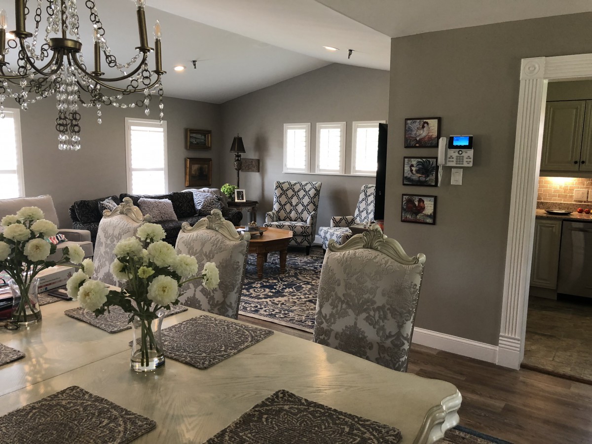 A cozy living and dining area with elegant decor and a chandelier.