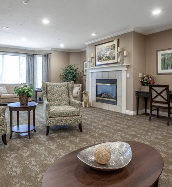 A cozy living room featuring a fireplace, comfortable seating, and elegant decor.