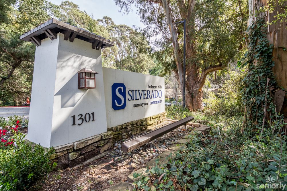 Entrance sign for Silverbaron surrounded by nature and trees.