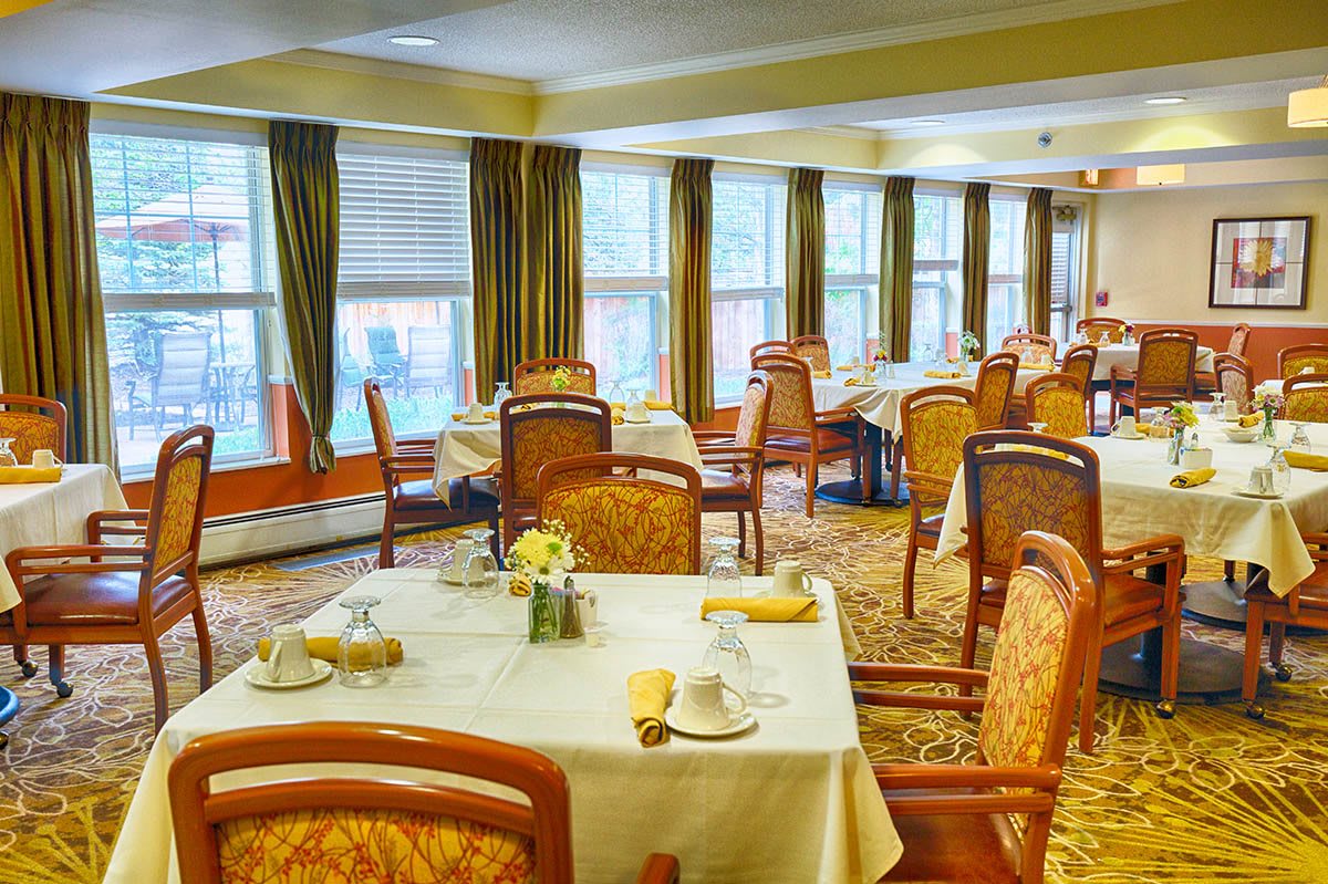 Elegant dining room with neatly arranged tables and chairs.