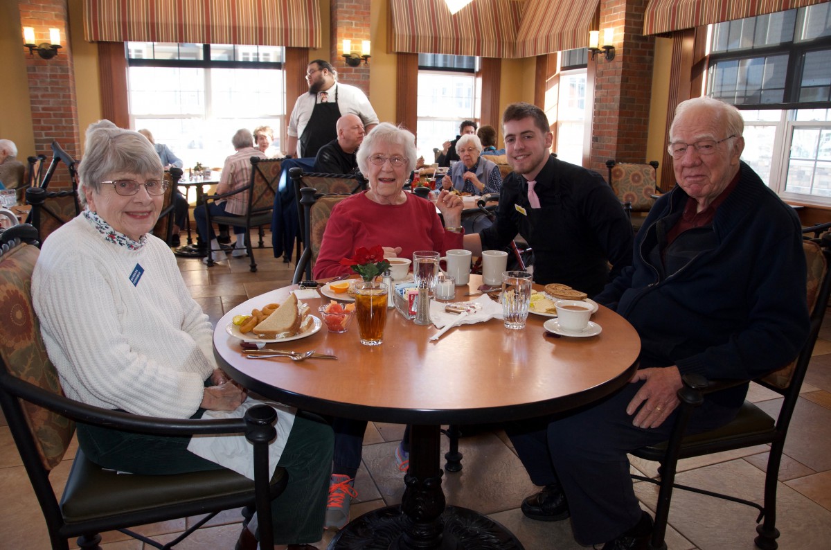 A group of people enjoying a meal together at a restaurant.