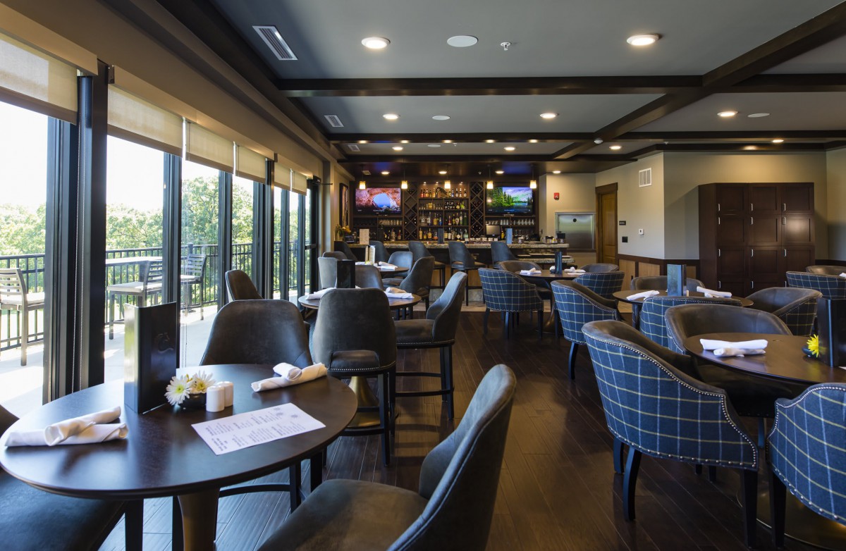 Modern restaurant interior with a spacious dining area and bar.