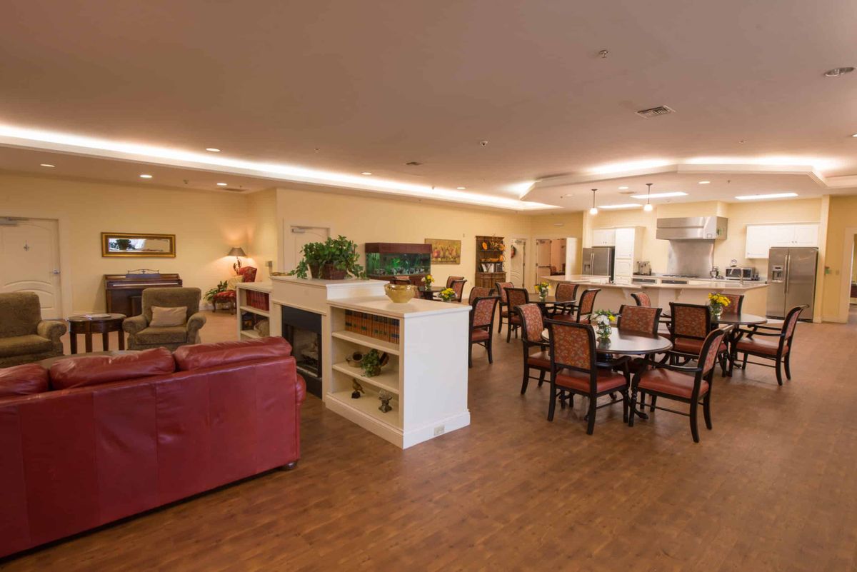 A cozy open-concept living room and dining area with comfortable seating and warm lighting.